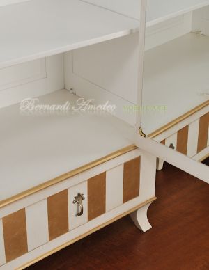 Classic wooden cabinet with white lacquered finish and hand-applied gold leaf